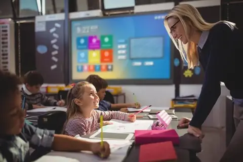 Teacher using a Newline interactive panel in a classroom